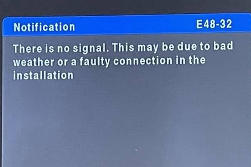 DSTV repair technician fixing signal loss issue with satellite signal meter and dish alignment in Johannesburg property