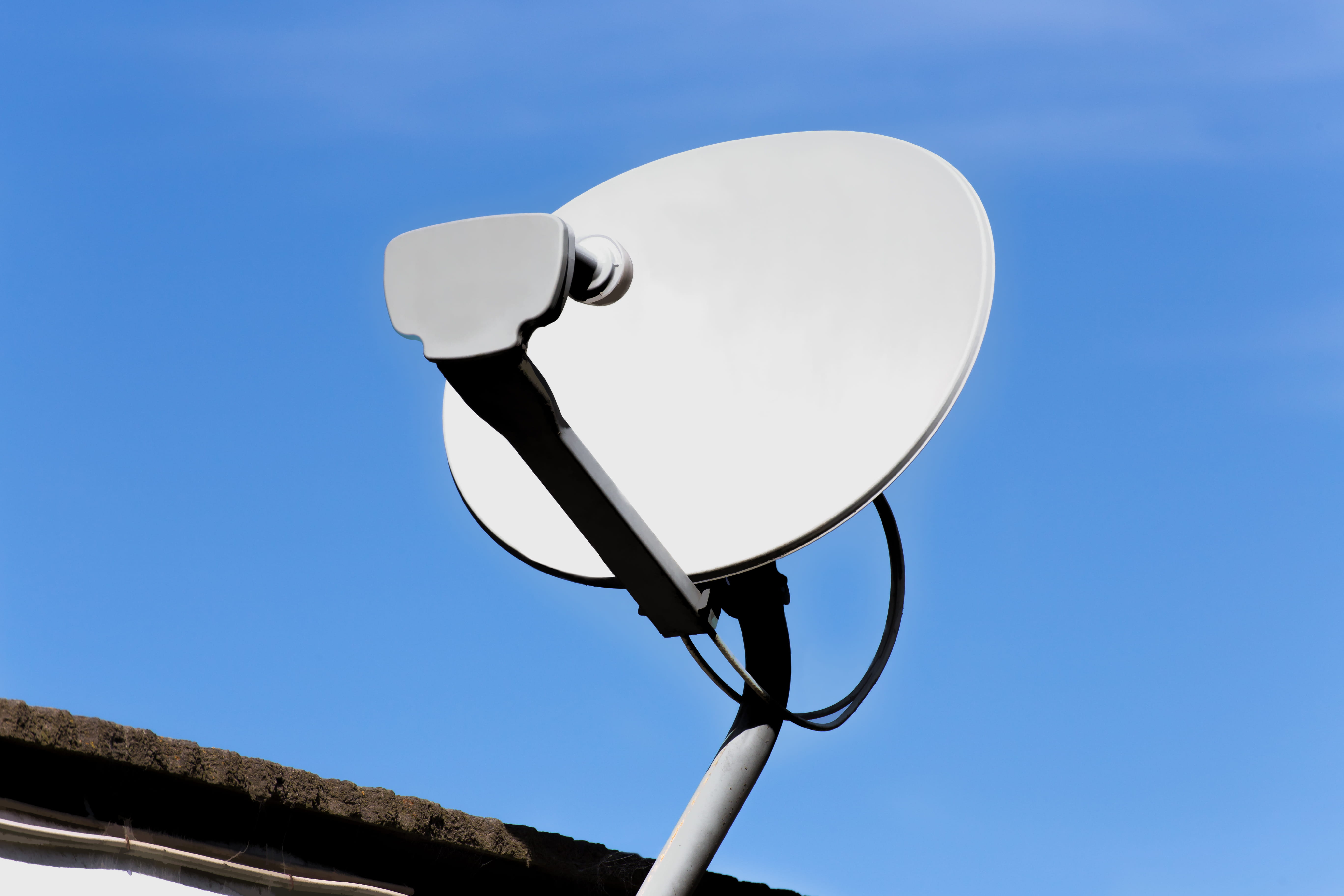 Newly installed DSTV satellite dish on a rooftop in Carlswald against a clear Highveld sky