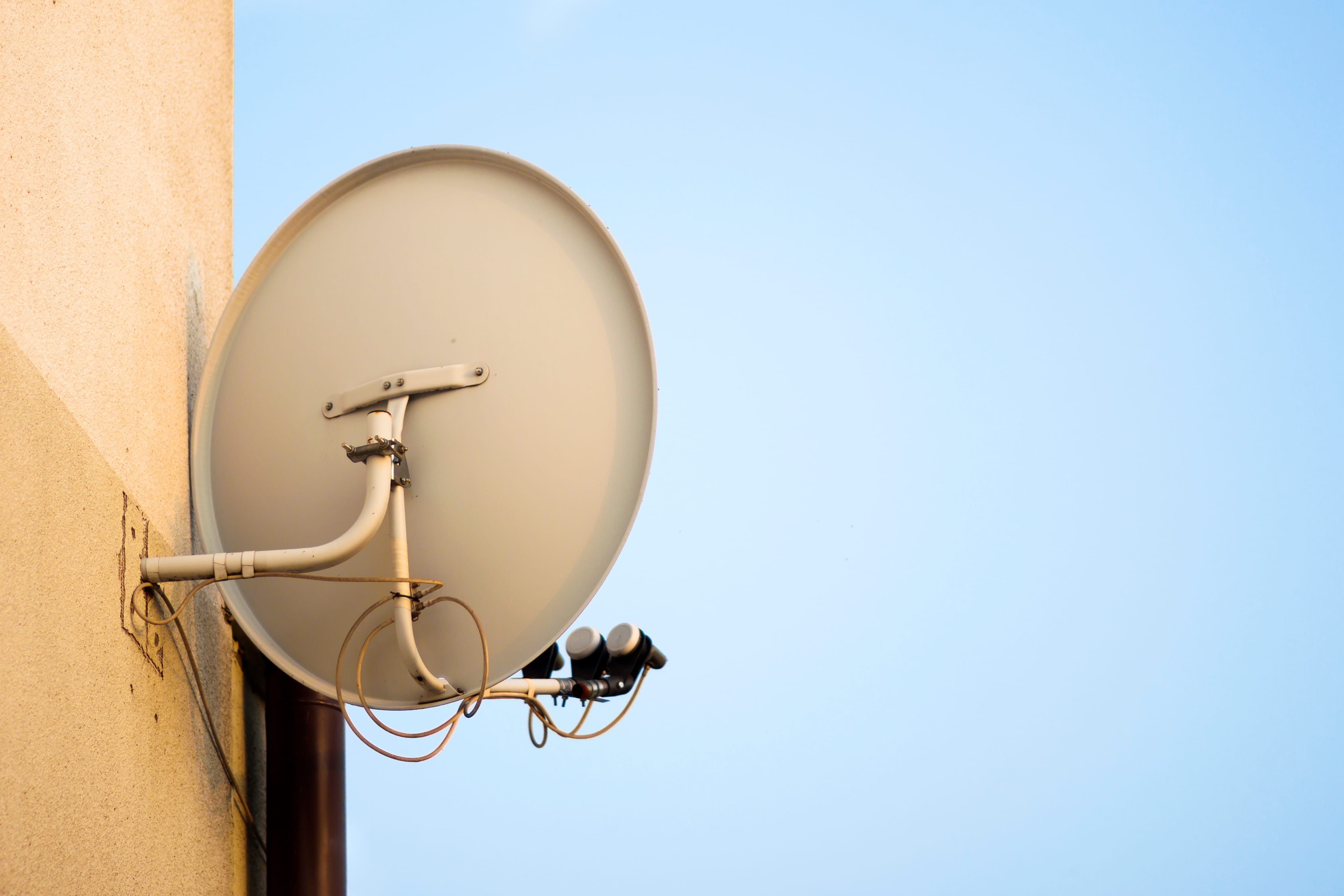 Residential DSTV dish installed on a city home in Little Falls with proper alignment to IS-20